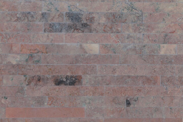 Dusty dark pink brick marble wall, close up.