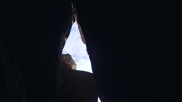 bottom view from narrow gorge with sheer cliffs on bright sun and blue sky