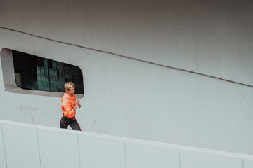 Women in sports clothes running in a modern urban environment. The concept of a sporty and healthy lifestyle