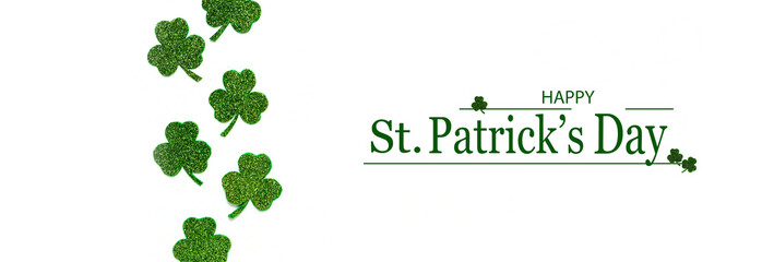 Happy St. Patrick's Day banner.Holiday background.St Patricks Day frame against a white background. Flat lay shamrocks.Copy space.Patrik's day banner