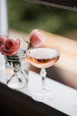 glass of rosé and roses