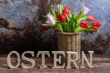Rustic standing wooden letters with the inscription - Easter on a wooden background. Easter concept