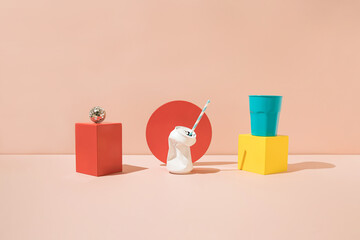 White crushed soda can, plastic cup,  disco ball and colored geometric shapes. Minimal summer concept.