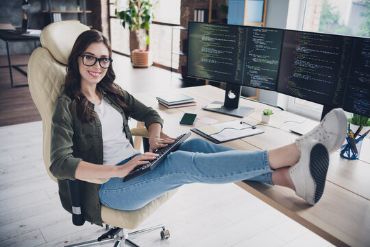 Photo of attractive positive lady hacker wear eyeglasses writing javascript indoors workplace workstation