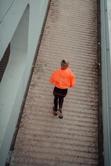 Top view photo of omen in sports clothes running in a modern urban environment. The concept of a sporty and healthy lifestyle