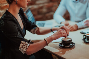 Happy businesspeople smiling cheerfully during a meeting in a coffee shop. Group of successful business professionals working as a team in a multicultural workplace.
