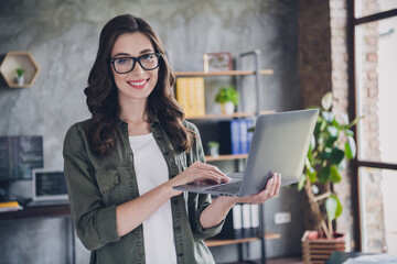 Photo of smiling cheerful lady boss wear eyeglasses typing modern device indoors workplace...