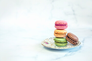 French Colorful Macarons Colorful Pastel Macarons on White Background pastel Pink and Brown Macaron with Fresh Blueberry, sweet cake stack copy space