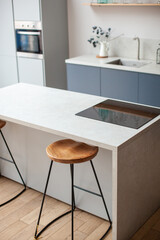 Modern kitchen interior in scandinavian style and gray tones. Kitchen island and bar stool. Close up. 