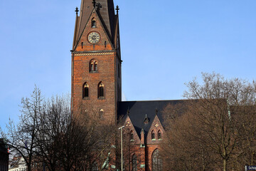 Obraz premium Old brick cathedral with clock tower