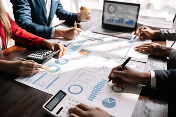 Businesspeople meeting to plan, analyze about business growth to plan future new business expansion using laptop and calculator for work.