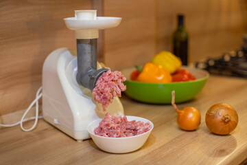 raw minced meat, cooking homemade minced meat in an electric meat grinder