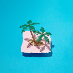 Palm tree against pastel pink torn paper and aquamarine green background. Summer holidays, beautiful exotic destinations. 