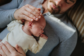 Close-up of father cudddling his little son. - obrazy, fototapety, plakaty