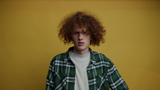 A young red-haired guy is confused, looks around