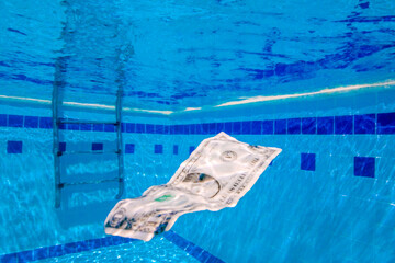 A dollar bill drowned in a blue pool. Homage to the music of Nirvana.