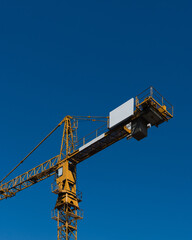 construction yellow crane on blue background