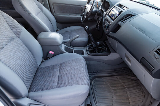 The interior of the car Toyota Hilux pickup with a view of the dashboard, steering wheel, front seats after cleaning before sale on parking