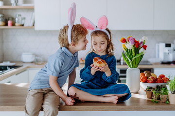 Little siblings enjoying easter time together in home.