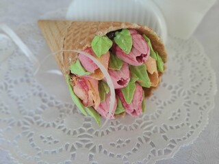 SMALL FLOWERS FROM HOMEMADE MARSHMALLOWS IN A WAFFLE CONE.