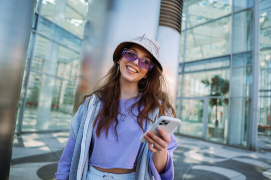 Young caucasian girl smiling happy using smartphone at city.
