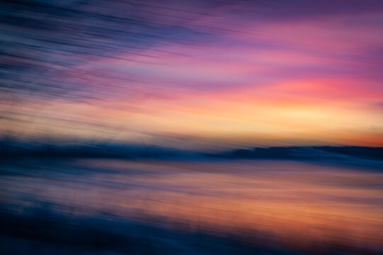Intentional camera movement photography on the river bank. Abstract color of a sunset with ICM create a blurred photo like a painting stroke.