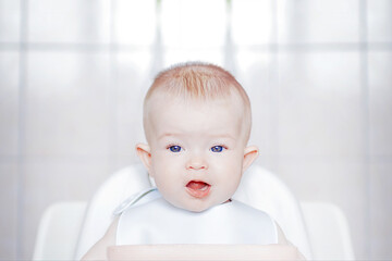 Little cute kid eats with his hands. Close-up of a child's face. Happy childhood and delicious...