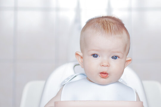 Little Cute Kid Eats With His Hands. Happy Childhood And Delicious Food. Grimaces Of A Cheery Baby. Funny Child Gets Dirty With Food. Close-up Of A Child's Face