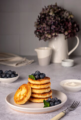 Food photography of pancakes, cottage cheese, blueberries, cream, breakfast; brunch, mint, morning