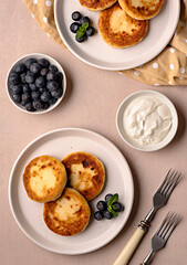 Food photography of pancakes, cottage cheese, blueberries, cream, breakfast; brunch, mint, morning