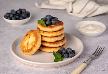 Food photography of pancakes, cottage cheese, blueberries, cream, breakfast; brunch, mint, morning