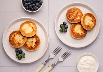 Food photography of pancakes, cottage cheese, blueberries, cream, breakfast; brunch, mint, morning