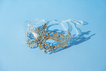 Festive face mask for masquerade or carnival celebration on colored background