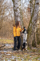 Naklejka na ściany i meble young teenage girl plays with her dog in nature. english setter