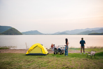 Landscape view of campground with camper people and camping tent with lake view and mountain at...