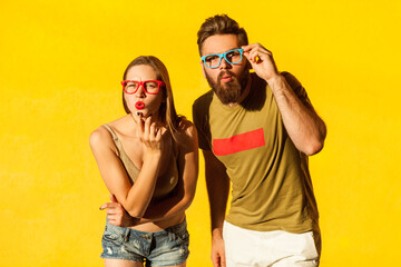 Surprised man and woman looking at camera with shocked facial expression, sees something amazing.