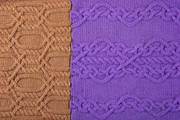 Knitted lilac and brown background. Large knitted fabric with a pattern. Close-up of a knitted blanket.