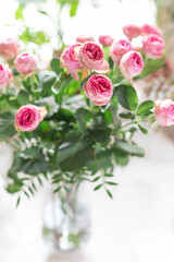 Fresh bouquet of pink roses in the glass vase  close up