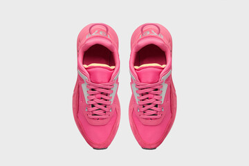 Pink fashion leather female slip-on tennis sneakers. Women's pair of sports training shoes for gym running isolated on white background. Placed together, view from above. Template, mock up