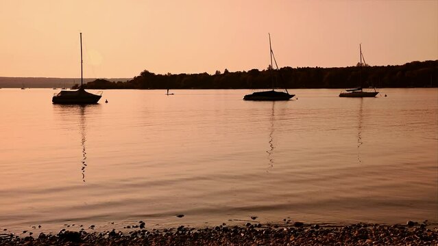 Evening mood with sailing boats at the lake Ammersee in Germany / Bavaria at sunset - AUGUST 23 2020.