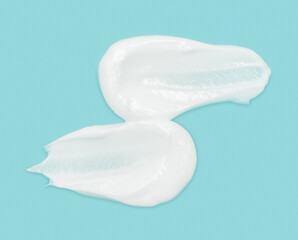 White cosmetic cream texture skincare lotion swatch. Face creme body moisturizer, hair conditioner smear smudge stroke on color background. Creamy beauty product close up. Shampoo, balm. Ointment