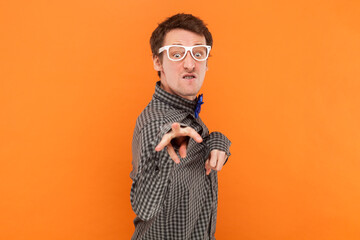Funny crazy disabled man nerd pointing and looking at camera with clenched teeth, wearing shirt.