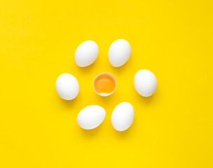 Chicken white eggs,yolk and half eggs iyellow background. Concept of foods rich in vitamin D. Diet product. Close-up