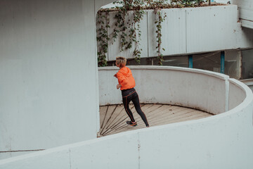 Women in sports clothes running in a modern urban environment. The concept of a sporty and healthy lifestyle