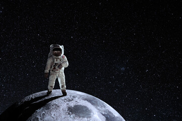 Obraz na płótnie Canvas Astronaut at the spacewalk on the moon. National Moon Day. Space Exploration Day. Elements of this image furnished by NASA.