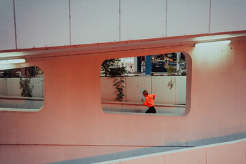 Women in sports clothes running in a modern urban environment et night time. The concept of a...