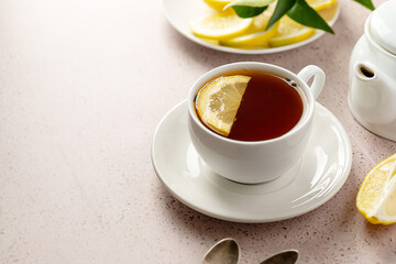 White cup of black tea and lemon slice. Drinking tea, copy space.