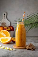Orange smoothie made with peach, ginger and orange, healthy drink.
