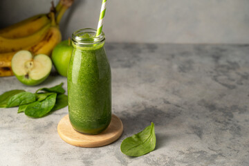 Bottle of green apple and banana smoothie, detox smoothie shake drink, copy space