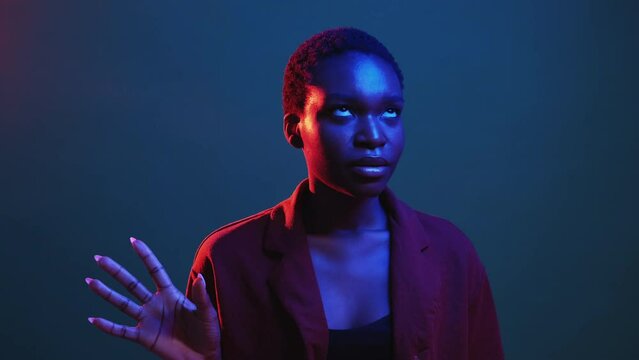 Enough gesture. Stop talking. Disagreement denial. Red blue neon color light annoyed skeptic woman sighing rolling eyes isolated on dark night gif loop boomerang animation.